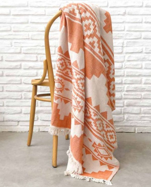 Peshtemal Turkish towel with Aztec pattern, orange on wooden chair - Shopping Blue